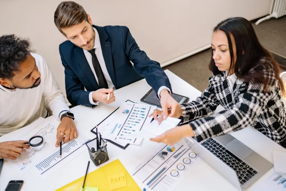 Advisers going through return figures and charts at a table