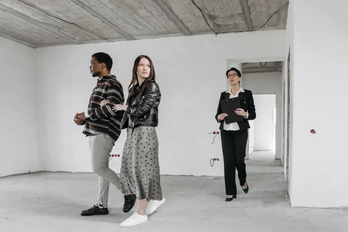 Agent walking buyers through an empty property before they make an offer