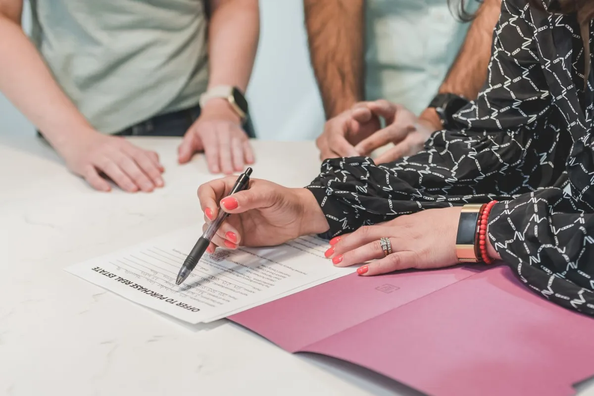 Buyers filling in an offer to purchase real estate
