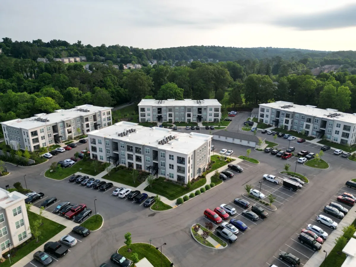 Aerial view of low-rise rental apartment buildings and their parking