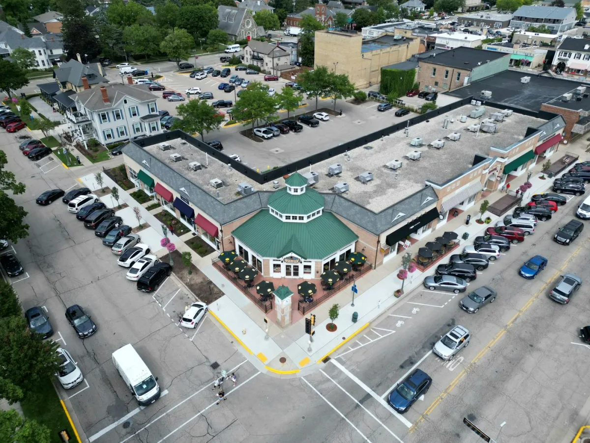 Aerial view of a suburban retail block and its parking lot