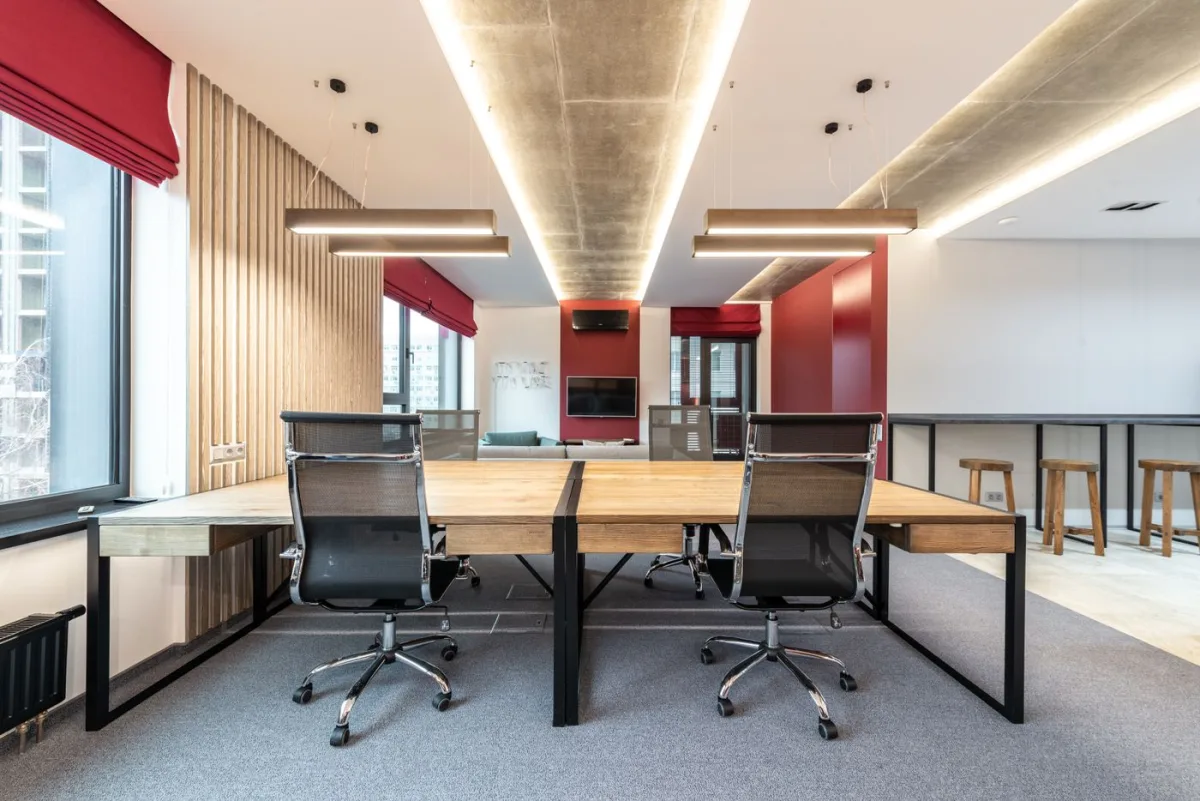 Vacant office suite with desks and chairs beside a window